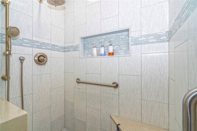 full bath with a tile shower