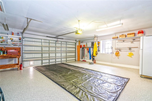 garage with a garage door opener and freestanding refrigerator