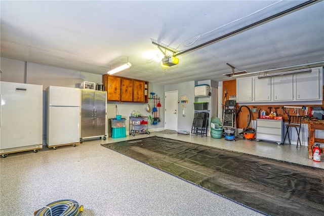 garage with freestanding refrigerator and a garage door opener