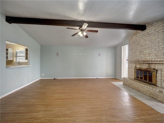 2100 Memorial Pkwy, Portland, TX 78374 - unfurnished living room with ceiling fan, wood finished floors, a fireplace, a sink, and baseboards