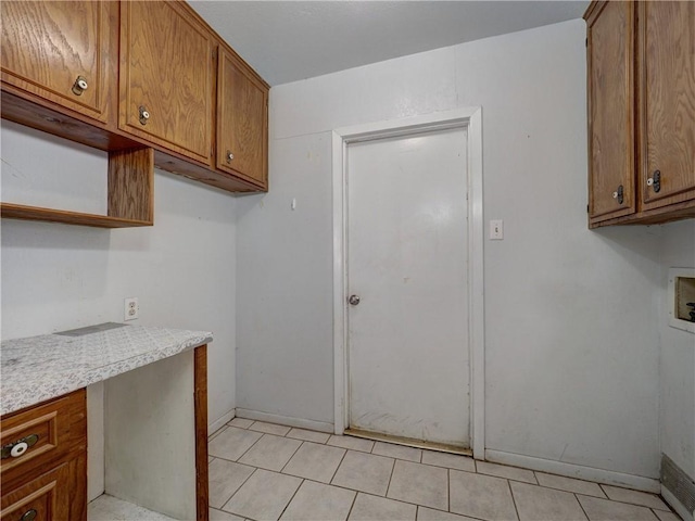 2100 Memorial Pkwy, Portland, TX 78374 - laundry room featuring hookup for a washing machine, cabinet space, baseboards, and light tile patterned flooring