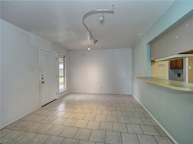 2100 Memorial Pkwy, Portland, TX 78374 - unfurnished living room featuring track lighting and baseboards