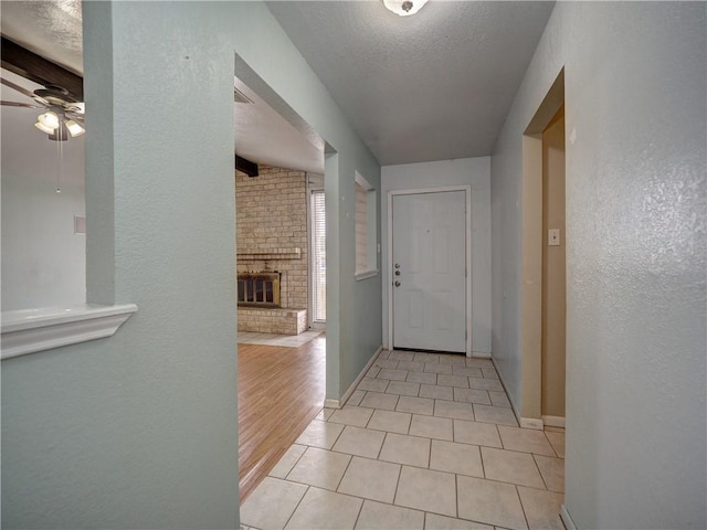 2100 Memorial Pkwy, Portland, TX 78374 - hallway with light tile patterned floors, a textured ceiling, baseboards, and a textured wall