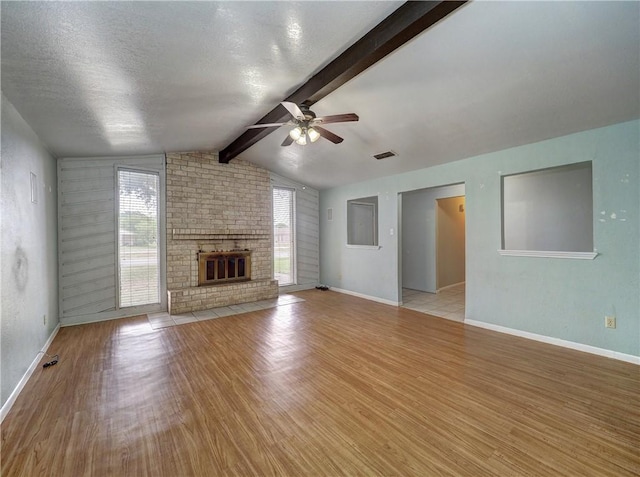 2100 Memorial Pkwy, Portland, TX 78374 - unfurnished living room featuring ceiling fan, plenty of natural light, wood finished floors, baseboards, and a textured ceiling