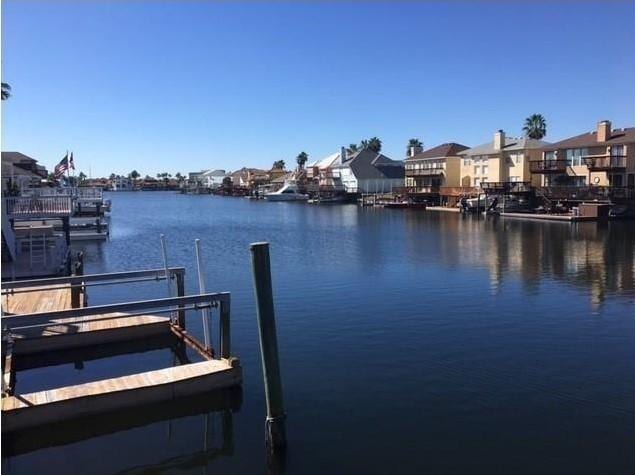 dock area with a residential view and a water view