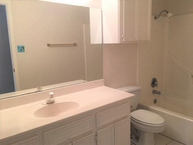 full bath featuring shower / bathtub combination, vanity, tile patterned flooring, and toilet