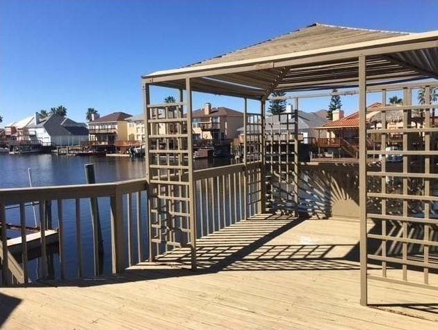 dock area featuring a residential view and a water view