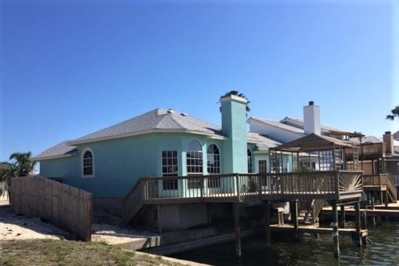 rear view of property featuring a deck