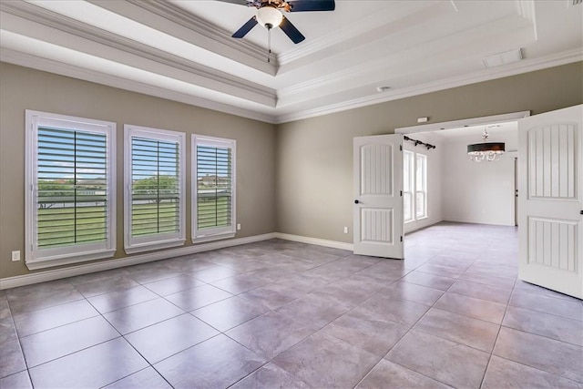 6241 Lago Vista Dr, Corpus Christi, TX 78414 - empty room featuring a tray ceiling, plenty of natural light, light tile patterned floors, and ornamental molding