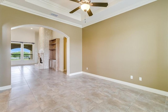6241 Lago Vista Dr, Corpus Christi, TX 78414 - spare room with arched walkways, ceiling fan, ornamental molding, light tile patterned floors, and a raised ceiling