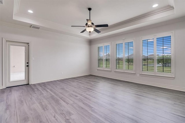 6241 Lago Vista Dr, Corpus Christi, TX 78414 - empty room featuring a tray ceiling, plenty of natural light, ornamental molding, ceiling fan, and wood finished floors