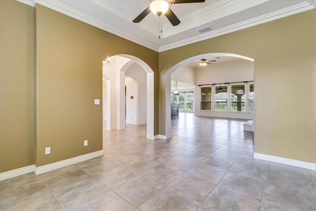 6241 Lago Vista Dr, Corpus Christi, TX 78414 - unfurnished room featuring a ceiling fan, crown molding, arched walkways, a tray ceiling, and light tile patterned floors