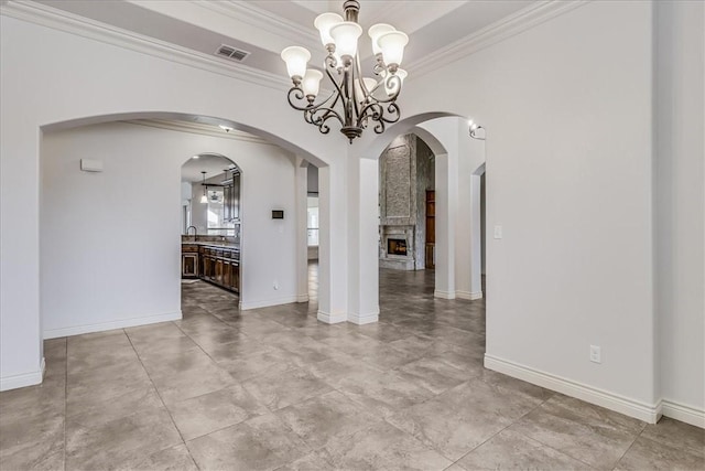 6241 Lago Vista Dr, Corpus Christi, TX 78414 - empty room featuring ornamental molding, a chandelier, and a fireplace
