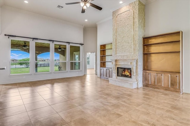 6241 Lago Vista Dr, Corpus Christi, TX 78414 - unfurnished living room with ceiling fan, ornamental molding, light tile patterned floors, a large fireplace, and recessed lighting