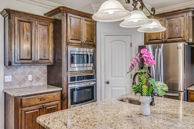 6241 Lago Vista Dr, Corpus Christi, TX 78414 - kitchen featuring stainless steel appliances, light stone countertops, decorative backsplash, crown molding, and decorative light fixtures