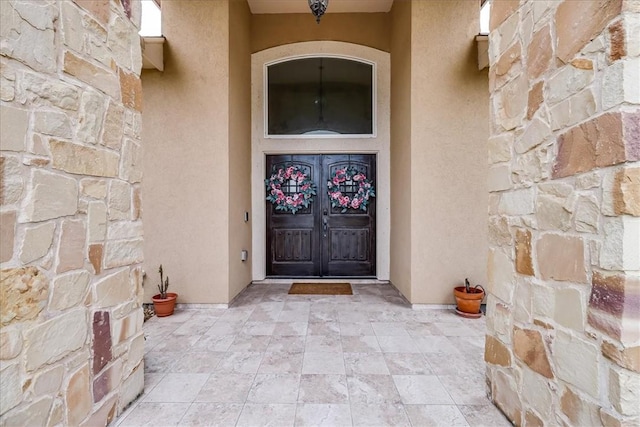 6241 Lago Vista Dr, Corpus Christi, TX 78414 - doorway to property featuring stucco siding, stone siding, and french doors