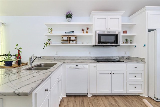 kitchen featuring open shelves, light wood-type flooring, white appliances, white cabinetry, and a sink