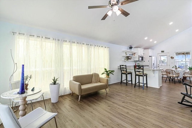 living area featuring recessed lighting, high vaulted ceiling, a ceiling fan, and wood finished floors