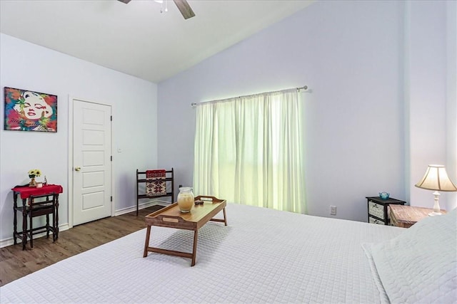 bedroom with a ceiling fan, lofted ceiling, wood finished floors, and baseboards