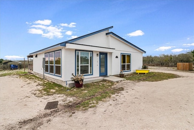 view of front of home featuring fence