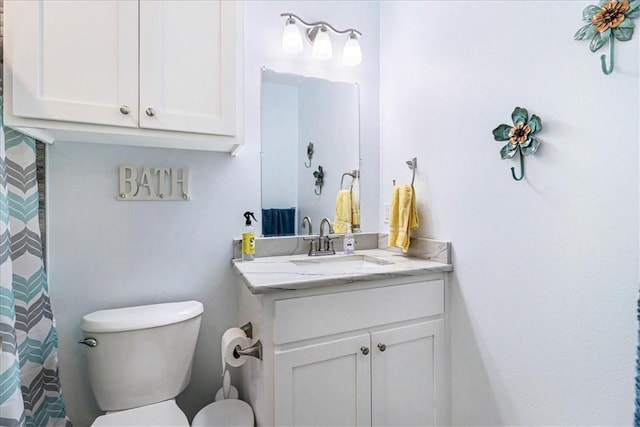 bathroom featuring toilet and vanity