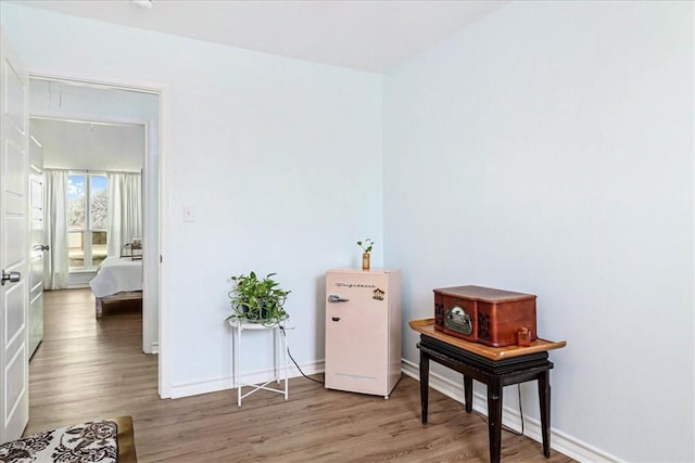 interior space featuring baseboards and wood finished floors