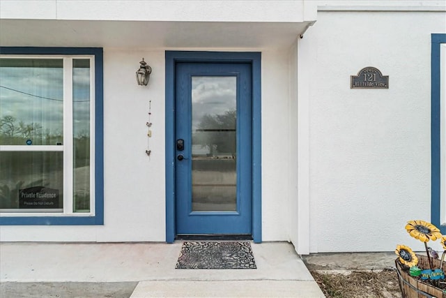 doorway to property with stucco siding