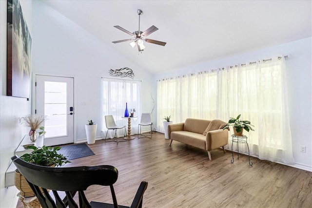 sitting room featuring wood finished floors, high vaulted ceiling, and ceiling fan