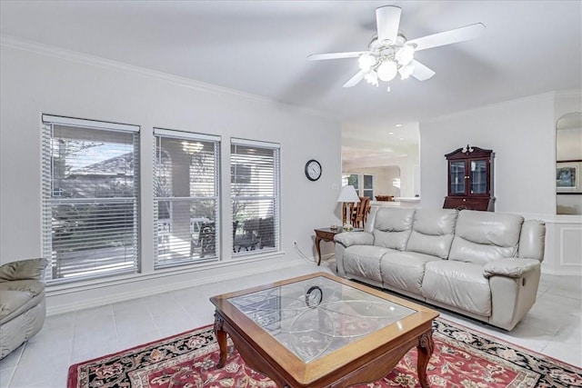 tiled living room with crown molding and ceiling fan