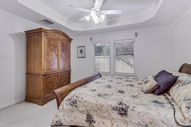 bedroom featuring ceiling fan, ornamental molding, a raised ceiling, and light carpet