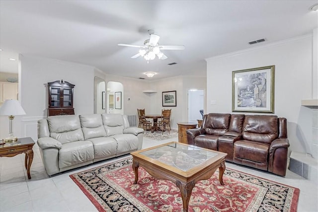 living room with light tile patterned floors, crown molding, and ceiling fan