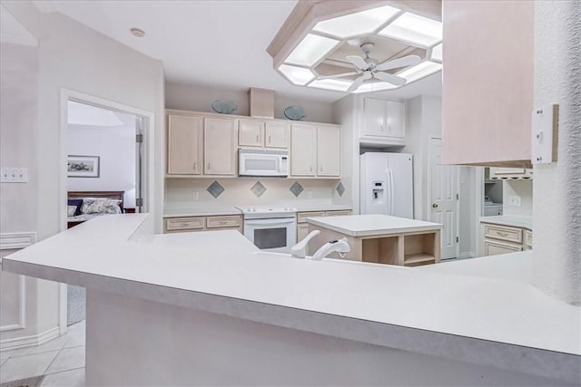 kitchen featuring a kitchen island, tasteful backsplash, light tile patterned floors, ceiling fan, and white appliances