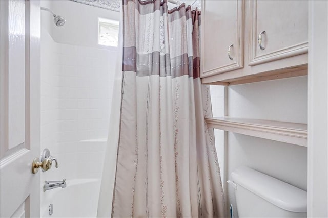 bathroom featuring shower / bathtub combination with curtain and toilet