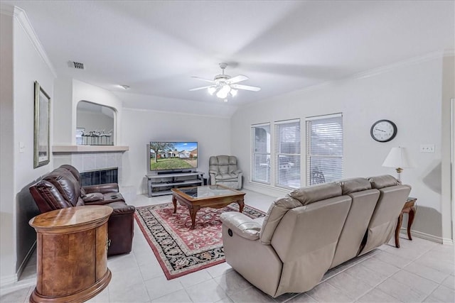 tiled living room with ceiling fan, ornamental molding, and a fireplace