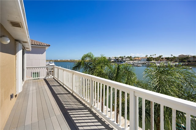 wooden terrace featuring a water view