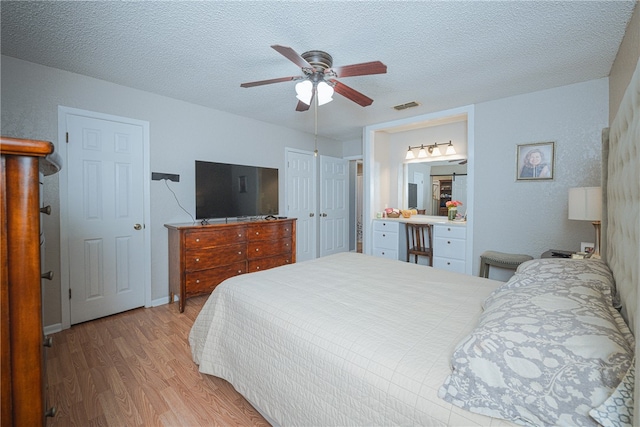 bedroom featuring ceiling fan, a textured ceiling, and light wood-type flooring