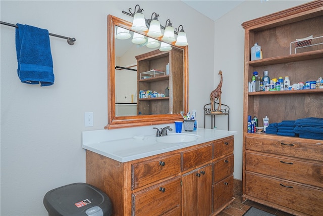 bathroom featuring vanity and lofted ceiling