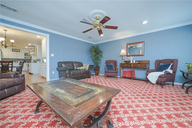 living room with ceiling fan with notable chandelier, carpet flooring, and crown molding