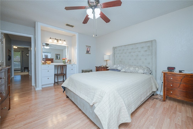 bedroom featuring a textured ceiling, light hardwood / wood-style flooring, and ceiling fan