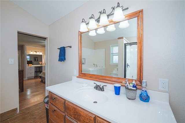 bathroom featuring wood-type flooring, vanity, an enclosed shower, and lofted ceiling