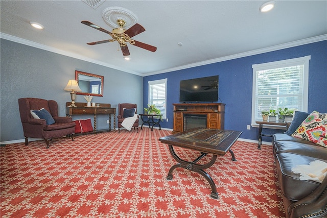 living room featuring ceiling fan, crown molding, and carpet