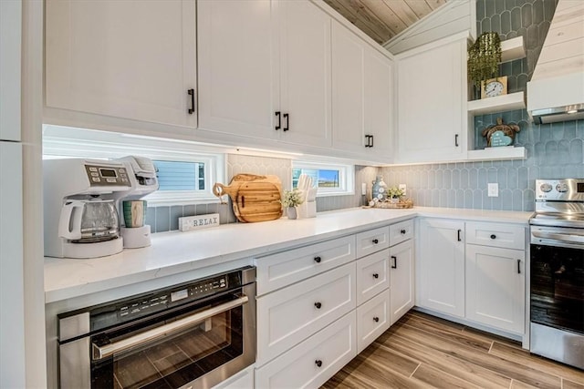 1911 Eskridge Rd, Port Aransas, TX 78373 - kitchen with appliances with stainless steel finishes, open shelves, and white cabinets
