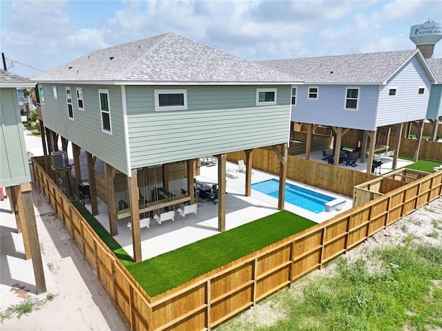 1911 Eskridge Rd, Port Aransas, TX 78373 - rear view of property with a patio area, roof with shingles, and a fenced backyard