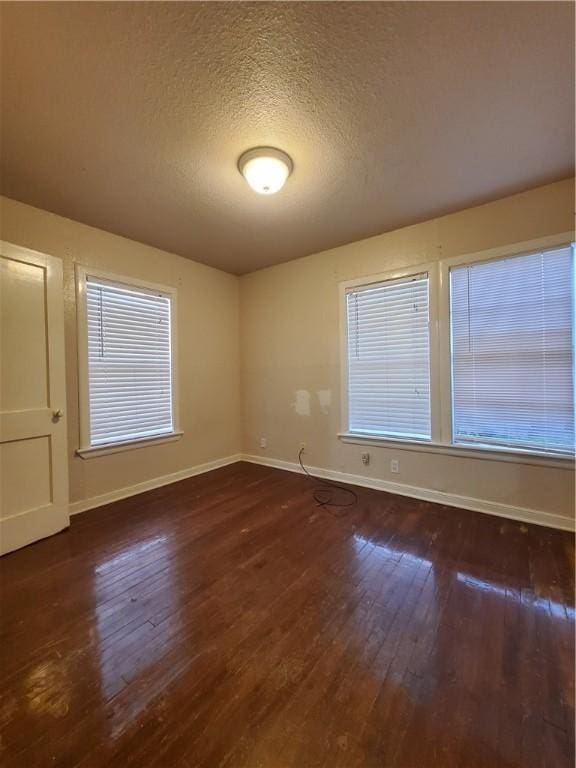 2838 Willard St, Corpus Christi, TX 78404 - empty room with dark wood-style floors and a textured ceiling
