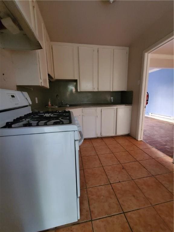 2838 Willard St, Corpus Christi, TX 78404 - kitchen featuring white gas range, under cabinet range hood, white cabinets, and light tile patterned flooring