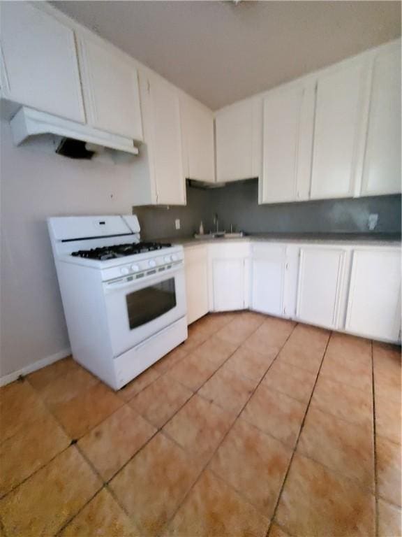 2838 Willard St, Corpus Christi, TX 78404 - kitchen featuring white range with gas cooktop, under cabinet range hood, white cabinetry, and light tile patterned floors