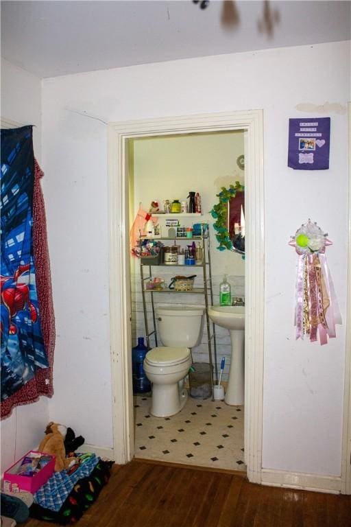 405 W Walton St, Beeville, TX 78102 - bathroom with wood finished floors and toilet