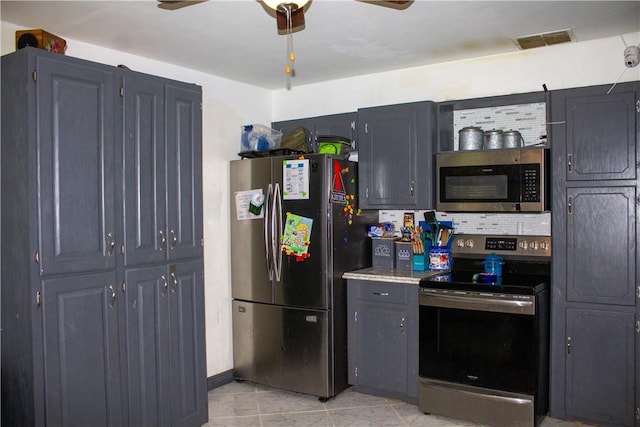 405 W Walton St, Beeville, TX 78102 - kitchen with appliances with stainless steel finishes, a ceiling fan, light tile patterned flooring, and light countertops
