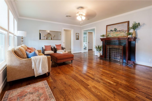 253 Melrose, Corpus Christi, TX 78404 - living area featuring a tiled fireplace, wood finished floors, crown molding, ceiling fan, and baseboards