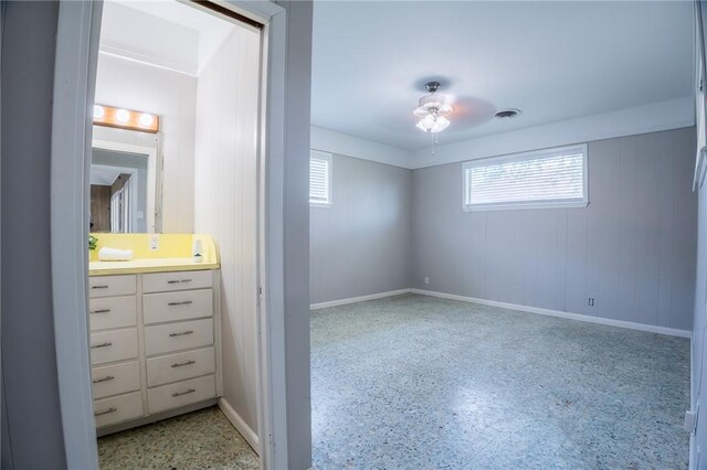 253 Melrose, Corpus Christi, TX 78404 - unfurnished bedroom with multiple windows, dark speckled floor, and baseboards